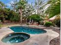 Inviting backyard pool and spa features a stone patio and lush landscaping, perfect for outdoor entertaining at 1201 E Le Marche Ave, Phoenix, AZ 85022