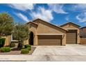 Lovely single-story home featuring a two-car garage, mature landscaping, and a classic desert-style design at 18428 W Robin Ln, Surprise, AZ 85387