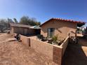 A welcoming backyard featuring a cozy patio and lush greenery for outdoor relaxation at 7706 N 173Rd Ave, Waddell, AZ 85355