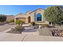 Charming stucco home showcasing a lovely stone walkway, desert landscaping and a two car garage at 27478 W Tonopah Dr, Buckeye, AZ 85396