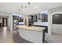 Modern kitchen featuring an expansive island, stainless steel appliances, and sleek dark cabinets at 27478 W Tonopah Dr, Buckeye, AZ 85396