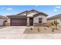 Attractive single-story home showcasing a two-car garage and low-maintenance desert landscaping at 16620 N Dante Way, Maricopa, AZ 85138