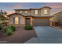 Charming two-story home featuring a stone-accented facade, tile roof, and a spacious two-car garage at 4102 S 186Th Ave, Goodyear, AZ 85338