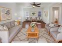 Bright and spacious living room with modern decor, a cozy seating arrangement, and ample natural light at 1948 W Busoni Pl, Phoenix, AZ 85023