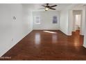 Large living room with wood flooring, two windows and neutral colors, creating a bright and airy atmosphere at 1948 W Busoni Pl, Phoenix, AZ 85023