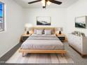Serene main bedroom featuring a modern bed frame, stylish nightstands, and a peaceful ambiance at 1948 W Busoni Pl, Phoenix, AZ 85023