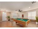Spacious game room with a pool table, neutral paint, tile flooring and natural light at 41229 W Laramie Rd, Maricopa, AZ 85138