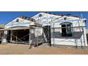 Under construction exterior elevation featuring scaffolding, window frames, and ThermalStar insulation wrap at 7682 W Saddlehorn Rd, Peoria, AZ 85383