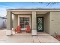 Inviting front porch with two red Adirondack chairs and a decorative green front door at 1325 E Monte Vista E Rd, Phoenix, AZ 85006