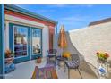 Cozy patio with comfortable seating, shaded by an umbrella, and decorated with potted plants for a relaxing outdoor retreat at 1820 N 7Th Ave, Phoenix, AZ 85007