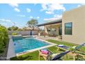 Beautiful backyard featuring a pool and lounge chairs on artificial turf at 3125 N 86Th Pl, Scottsdale, AZ 85251