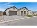 Inviting single-level home with a stylish garage door, paved driveway, and arched front porch at 3624 N 59Th St, Mesa, AZ 85215