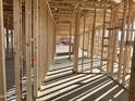 Interior framing of a new home, showing the open floor plan and natural light at 5625 W Mcneil St, Laveen, AZ 85339