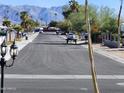 Quiet residential street with mountain views and mature landscaping at 394 N Pinyon Dr, Apache Junction, AZ 85120