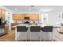 Open kitchen with a large island, stainless steel appliances, and modern finishes at 25238 N 172Nd Ln, Surprise, AZ 85378