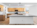 Open kitchen with a large island, modern countertops, and stainless steel appliances at 25238 N 172Nd Ln, Surprise, AZ 85378