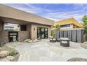 Charming back patio features comfortable seating, stone accents, and lush desert landscaping, creating a private oasis at 37200 N Cave Creek Rd # 1023, Scottsdale, AZ 85262