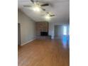 Spacious living room with a cozy brick fireplace and sleek ceiling fans at 1302 W Estrella Dr, Chandler, AZ 85224