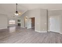 Bright living room features wood-look tile floors and a ceiling fan at 42473 W Sparks Dr, Maricopa, AZ 85138