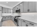 Stylish kitchen featuring gray cabinets, quartz countertops, and stainless steel gas range at 5845 S Romano --, Mesa, AZ 85212