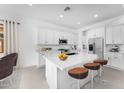 Bright kitchen features a central island, stainless steel appliances, and white cabinets at 5851 S Romano --, Mesa, AZ 85212