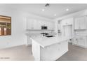 Bright kitchen with quartz countertops, white cabinets, and a large island at 5851 S Romano --, Mesa, AZ 85212