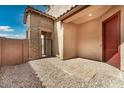 Private patio featuring stone walls, pavers, and a gate, perfect for outdoor relaxation at 5851 S Romano --, Mesa, AZ 85212