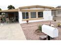 Inviting single-story home with a covered patio perfect for outdoor seating at 8257 E Dutchman Dr, Mesa, AZ 85208