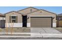 Beautiful single-story home features neutral tones, desert landscaping, and a two-car garage at 16034 W Desert Hollow Dr, Surprise, AZ 85387