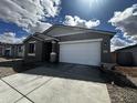 Single-Gathering home featuring a two-car garage, modern gray siding and decorative stone pillar at 4317 E Bradford Ave, San Tan Valley, AZ 85143