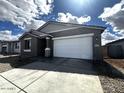 Charming single-story home featuring a two-car garage and low maintenance desert landscaping at 4317 E Bradford Ave, San Tan Valley, AZ 85143