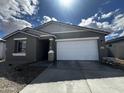 Single-Gathering home featuring a two-car garage, modern gray siding and decorative stone pillar at 4317 E Bradford Ave, San Tan Valley, AZ 85143