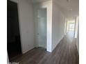 Bright hallway with wood-look tile floors leading to various rooms at 4317 E Bradford Ave, San Tan Valley, AZ 85143