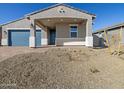 Well-maintained front exterior features a two car garage and a inviting covered porch at 4832 N 177Th Dr, Goodyear, AZ 85395