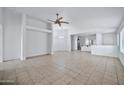 Bright living room with tile floors and ceiling fan at 10813 W Piute Ave, Sun City, AZ 85373