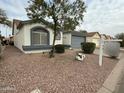 Single-story home with desert landscaping, two-car garage, and a view of the charming neighborhood at 1812 E Peach Tree Dr, Chandler, AZ 85249