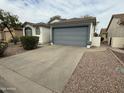 Single-story home featuring a two-car garage with a concrete driveway and low maintenance landscaping at 1812 E Peach Tree Dr, Chandler, AZ 85249