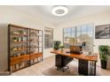 Bright home office features built-in shelving and large window at 2023 E Willow Wick Rd, Gilbert, AZ 85296