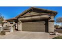 House exterior showcasing a two-car garage and neutral color palette at 30341 N Saddlebag Ln, San Tan Valley, AZ 85143