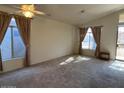 Bright living room with large windows and neutral carpeting at 4850 W Erie St, Chandler, AZ 85226