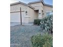 Tan one-story house with a two-car garage and cacti at 805 W Sunset Dr, Coolidge, AZ 85128