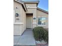 Front entry with a security door and small shrubs at 805 W Sunset Dr, Coolidge, AZ 85128