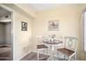 Small breakfast nook with white table and chairs at 10606 W Granada Dr, Sun City, AZ 85373