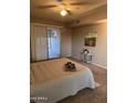 Main bedroom with patio access and ceiling fan at 10606 W Granada Dr, Sun City, AZ 85373