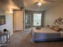 Main bedroom with carpeted floors and ensuite bathroom at 10606 W Granada Dr, Sun City, AZ 85373