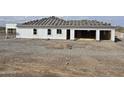 Exterior view of a new home with tile roofing materials and an open garage at 1907 W Brooke Ln, Queen Creek, AZ 85144