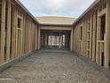 A view through the interior framing of a new home, showing the open floor plan at 1907 W Brooke Ln, Queen Creek, AZ 85144