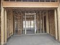 Interior framing of a new home showing an open doorway to the future living space at 1907 W Brooke Ln, Queen Creek, AZ 85144