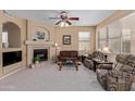 Cozy living room features a fireplace and comfortable seating at 17963 W Ryans Way, Surprise, AZ 85374