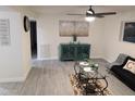 Bright living room with gray tile floors, comfy couch, and stylish decor at 418 W Hartford Rd, Kearny, AZ 85137